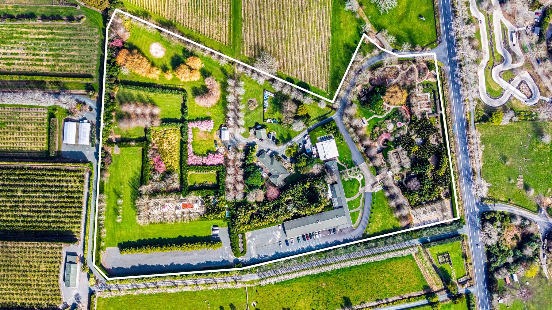 Aerial with the 40 Omaha Flats Road title boundary outlined — galleries, gardens, Rothko Restaurant and carparking